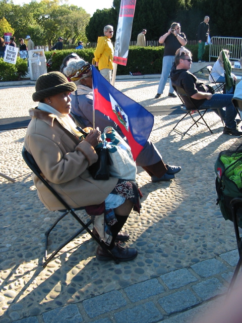A woman holds a Haitian flag
