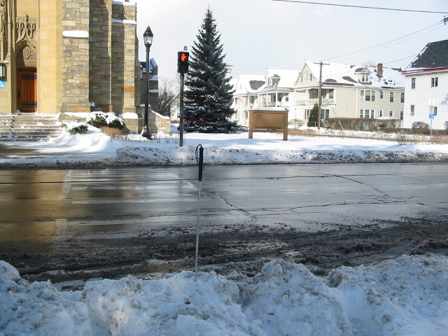 Cane in snowbank blocking crosswalk
